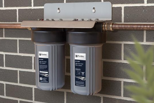 small water filter attached to brick wall